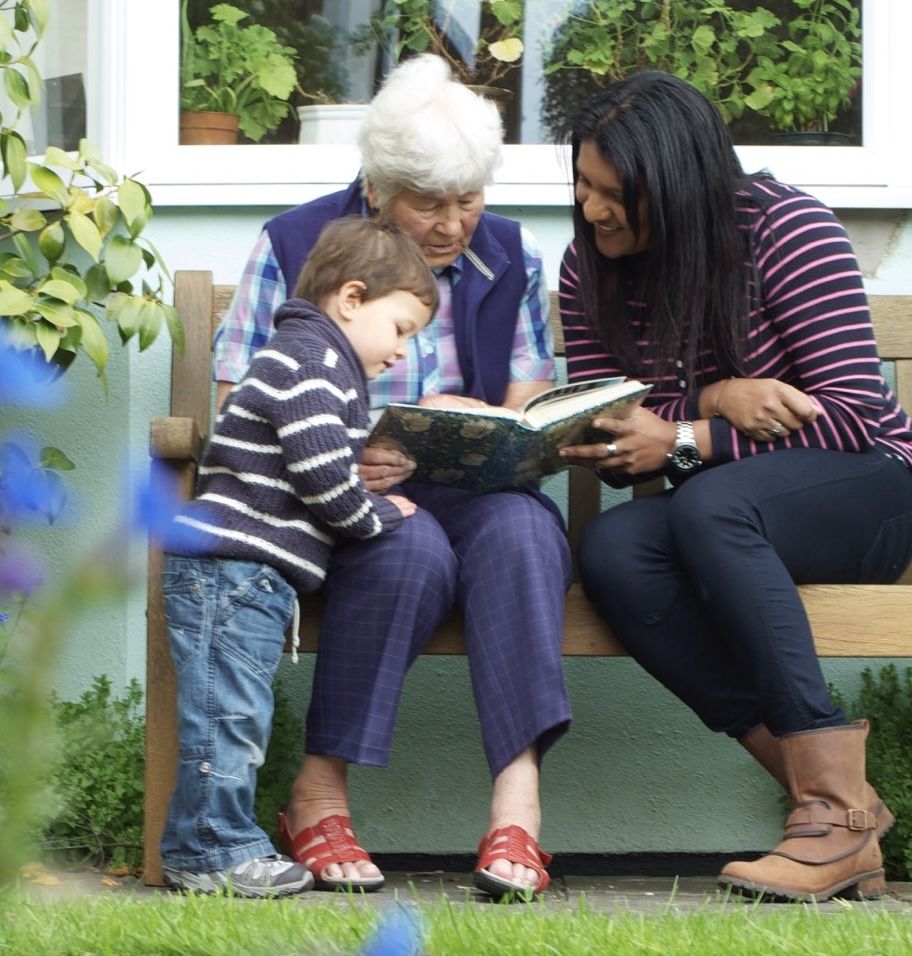 Family reading a book together at home